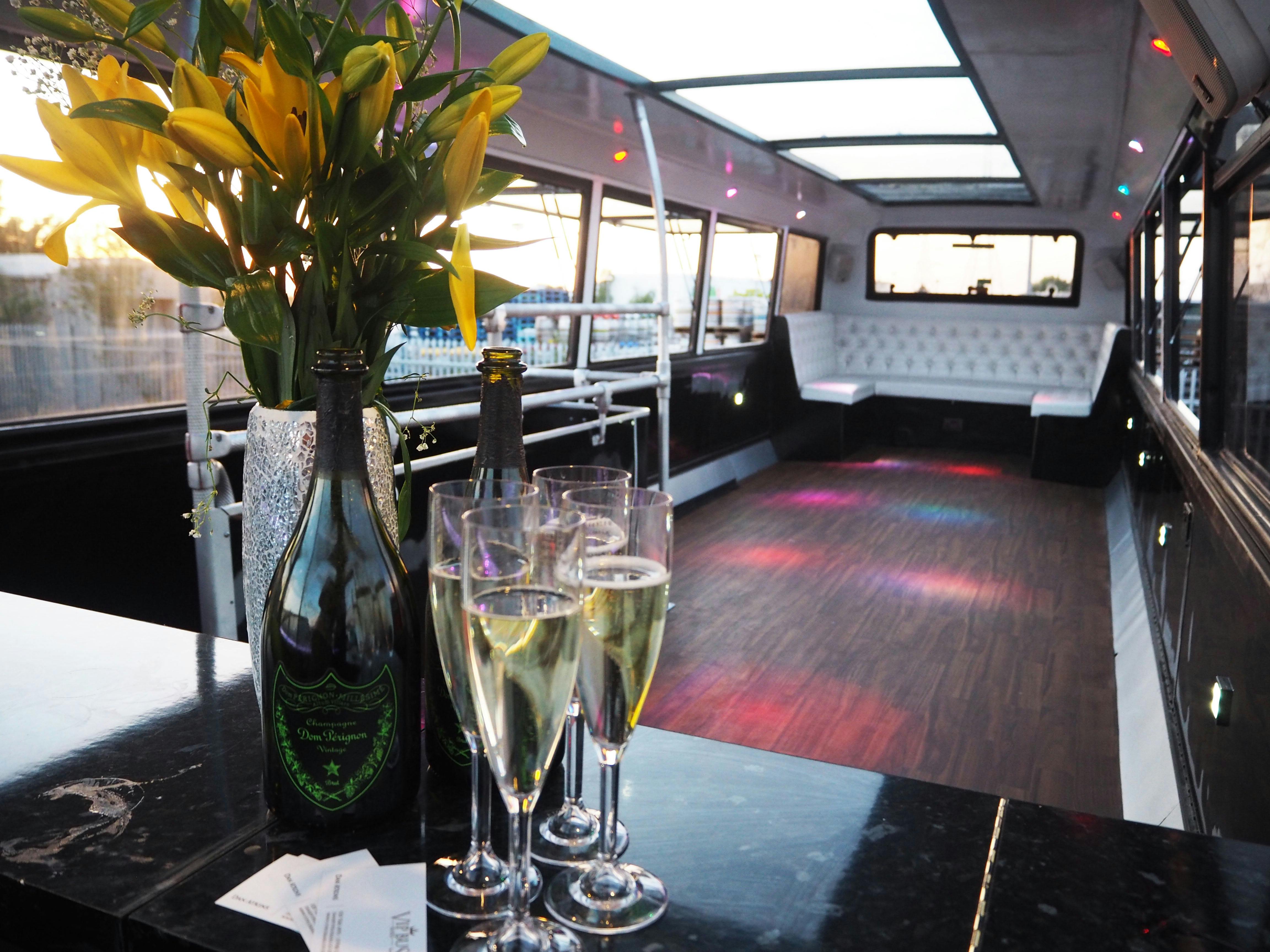 VIP bus event space with elegant champagne glasses for corporate events and private parties.