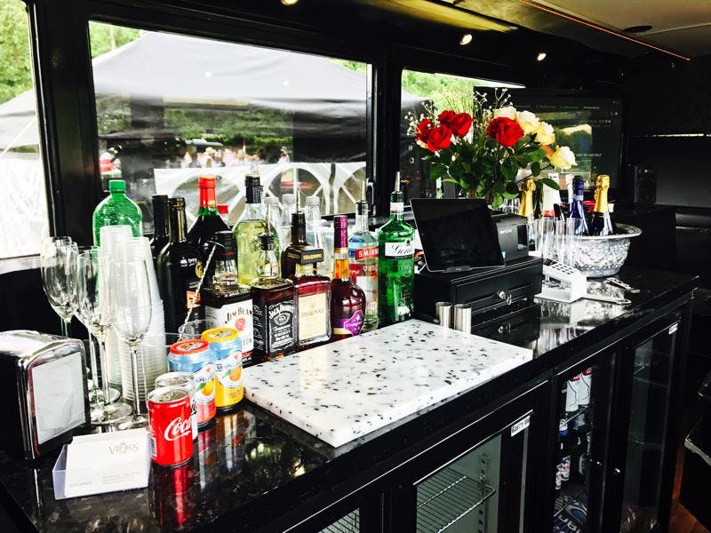 VIP bus bar with sleek black counter, ideal for events and celebrations.