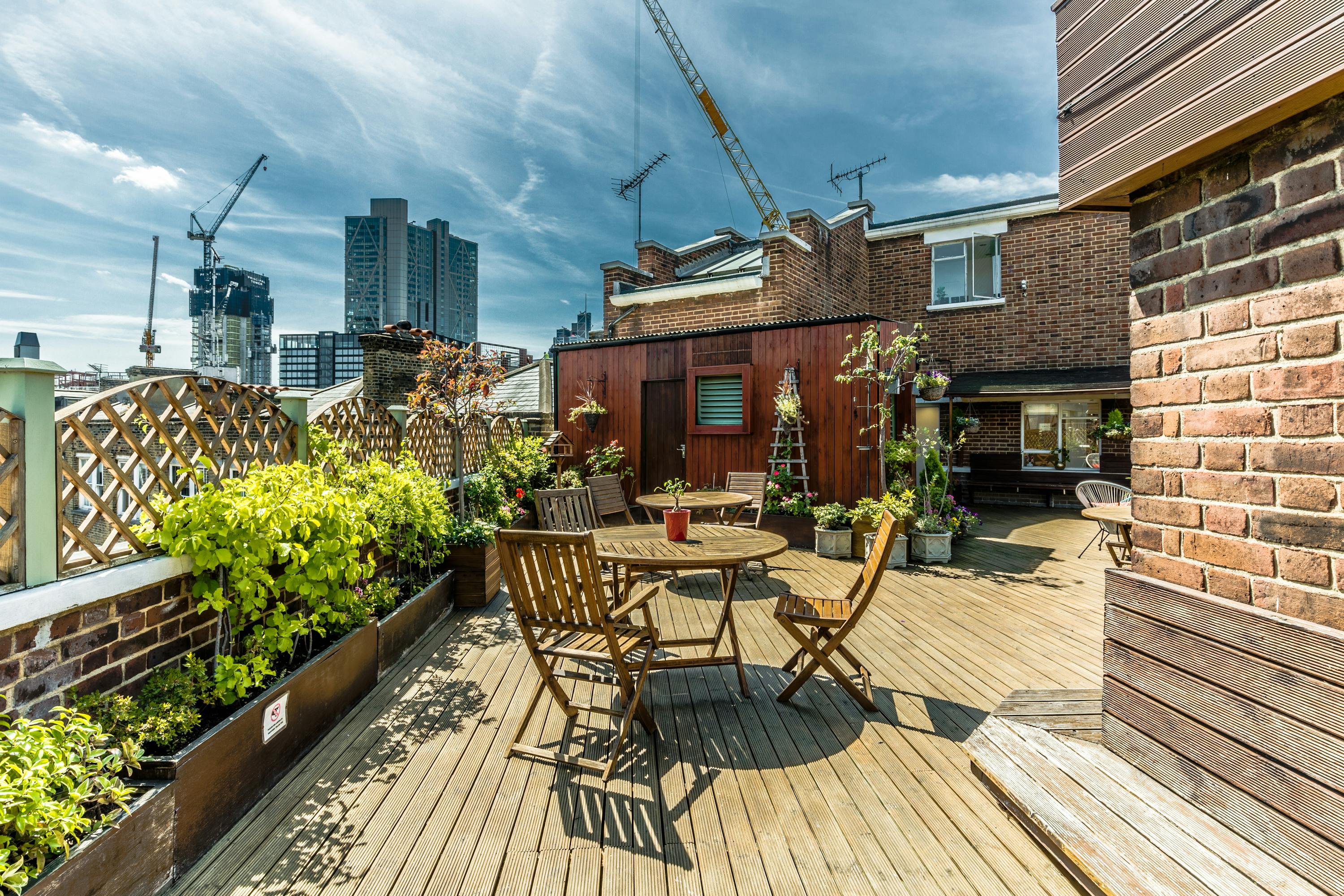 Charming rooftop venue with wooden deck, ideal for gatherings and networking events.