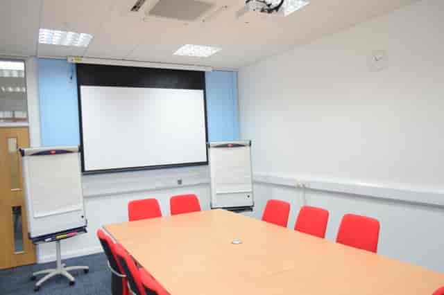 Meeting Room 3 at HAD with red chairs, ideal for workshops and presentations.