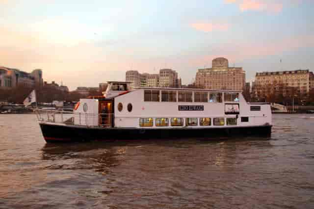 Stylish event boat with panoramic windows for unique gatherings on the river.