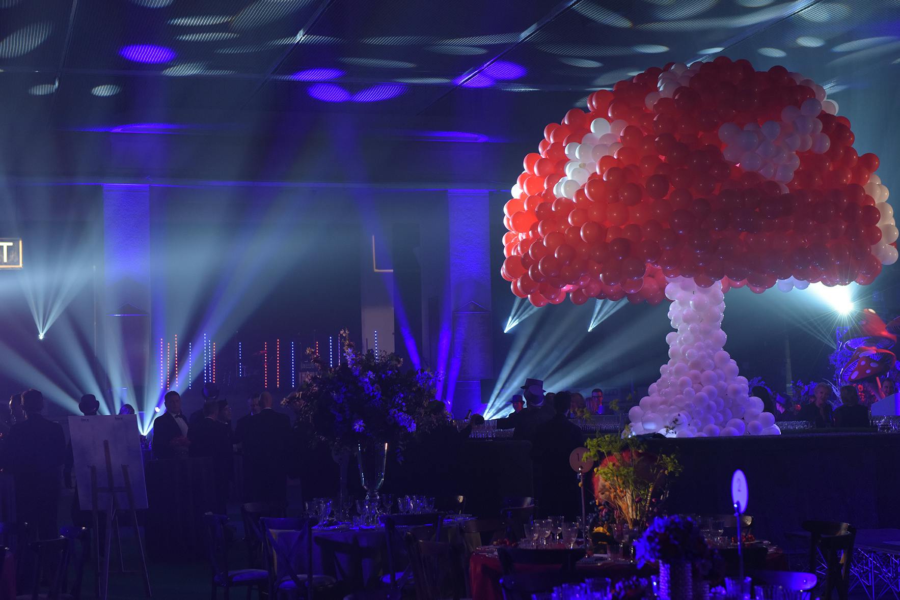 Lawrence Hall event space with vibrant mushroom balloon installation and dynamic lighting.