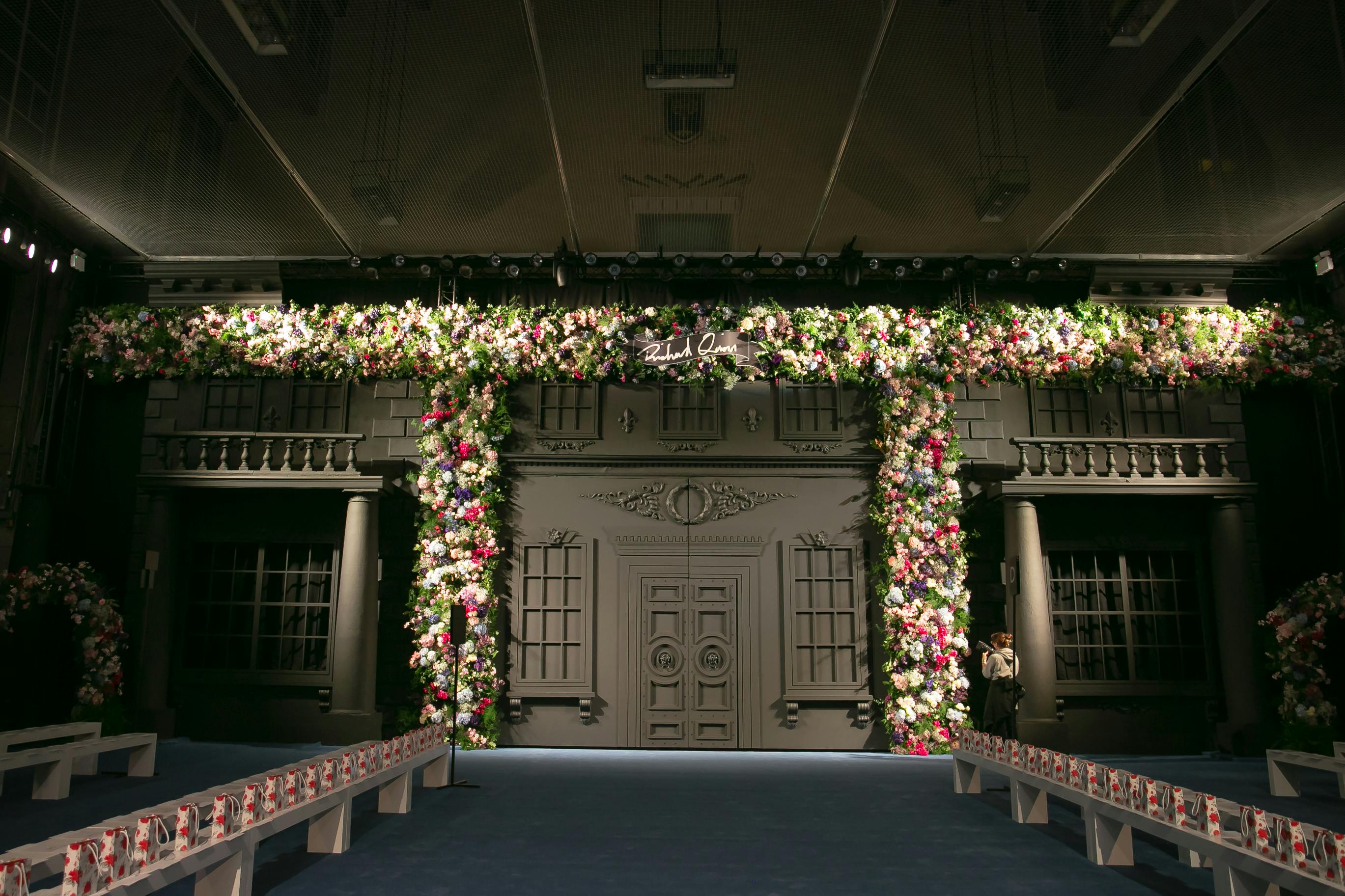 Elegant floral arch in Lawrence Hall, perfect for upscale fashion shows and events.