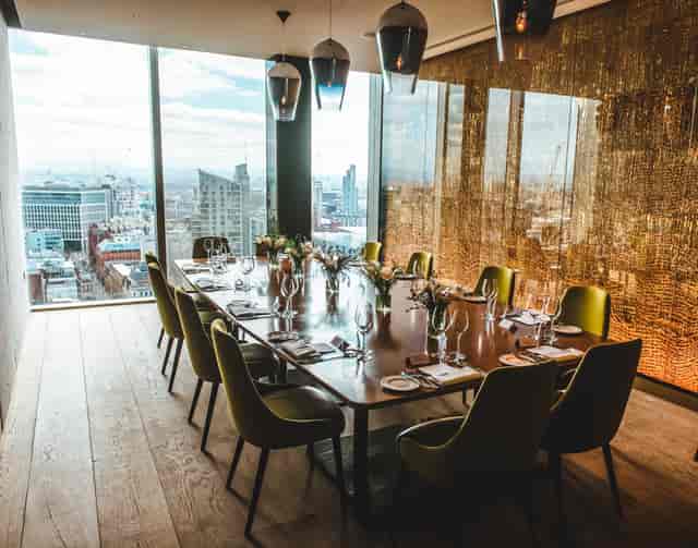 Private dining room with panoramic city view for corporate events and intimate gatherings.
