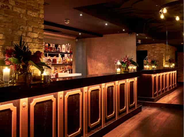 Upscale Kadies Club bar with exposed brick for corporate receptions and VIP networking events.