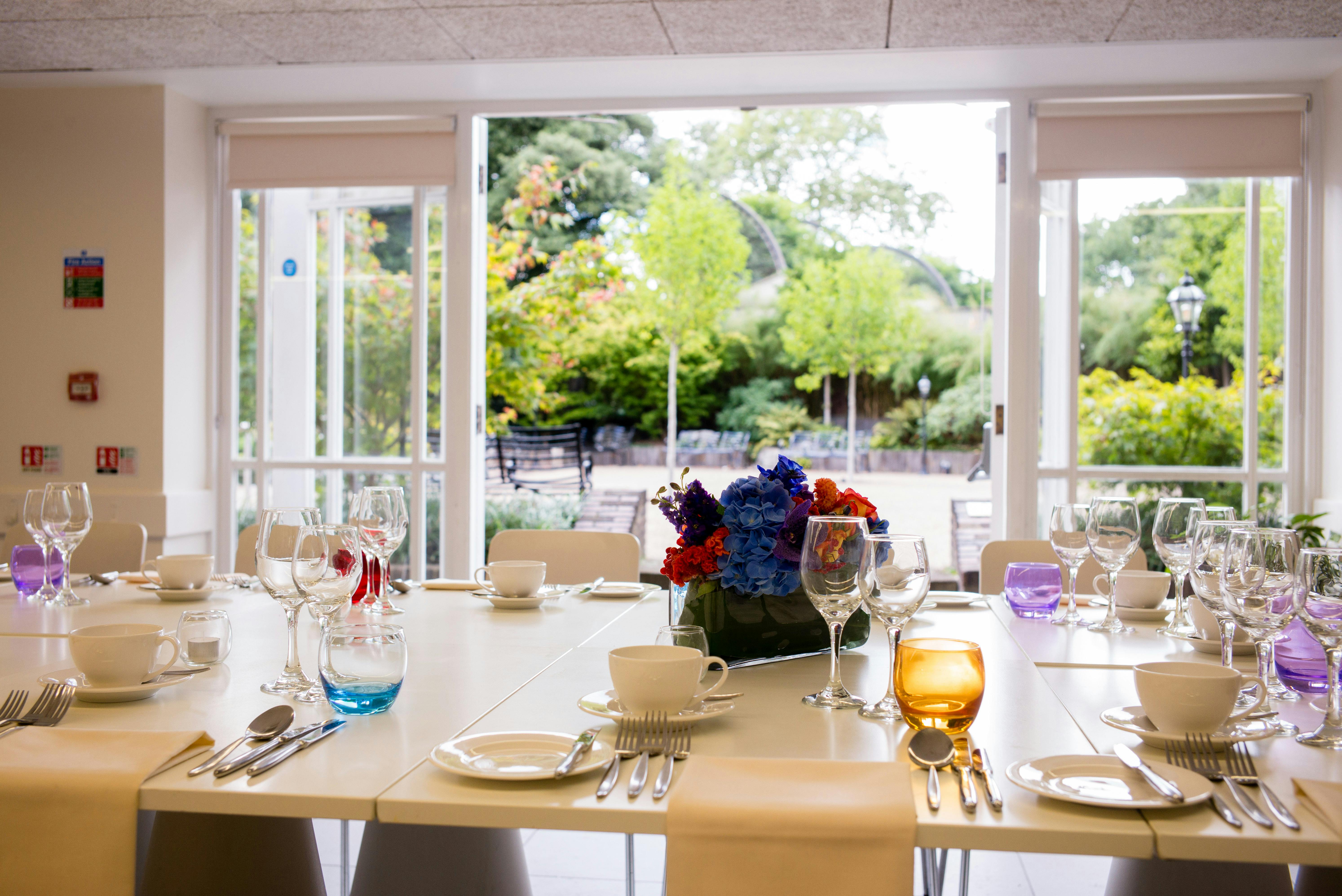 Elegant dining table in ZSL London Zoo's Garden Room for upscale events and gatherings.