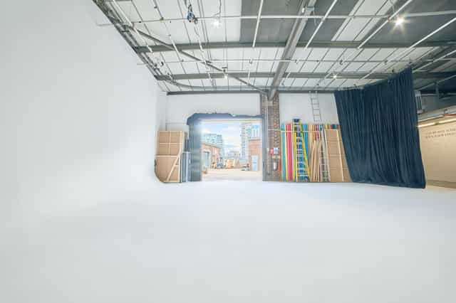 Versatile event space with white backdrop at Cineview Studios, ideal for corporate events.