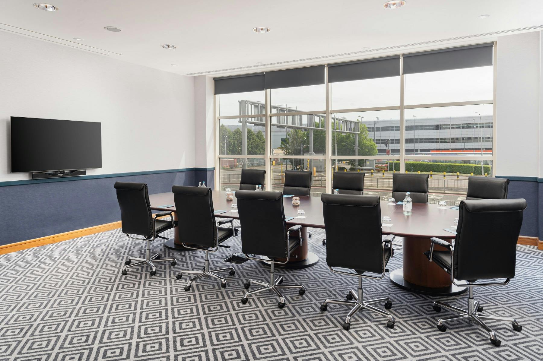 Executive Boardroom at Sofitel London Gatwick with oval table, ideal for meetings and conferences.