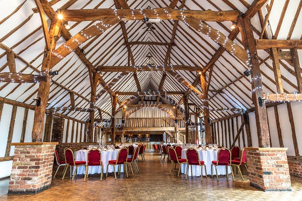 Lodge Barn at Knebworth House: rustic beams, elegant tables for weddings and events.