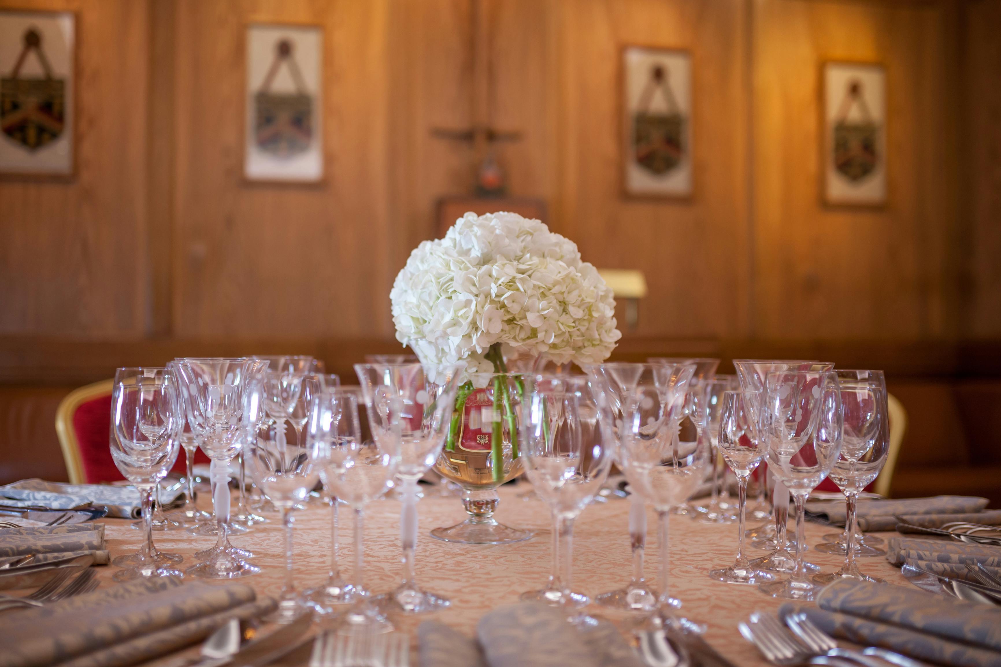 Elegant dining table with white hydrangeas at Bakers' Hall for formal events.