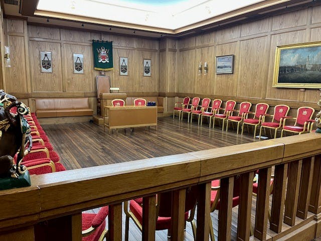 Formal meeting room in Bakers' Hall with wood-paneled walls, ideal for conferences.