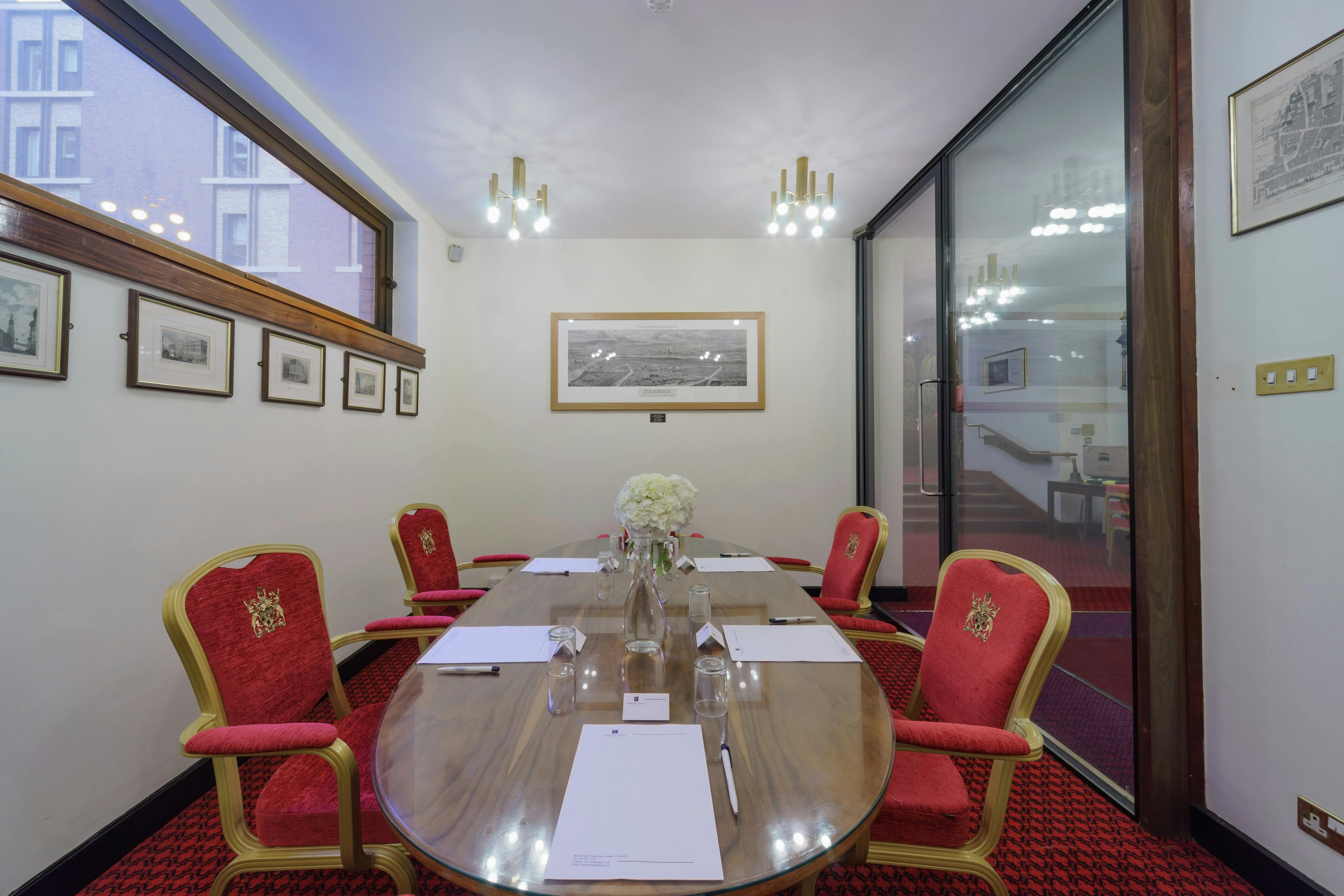 Elegant meeting room with round table and plush chairs, perfect for corporate events.