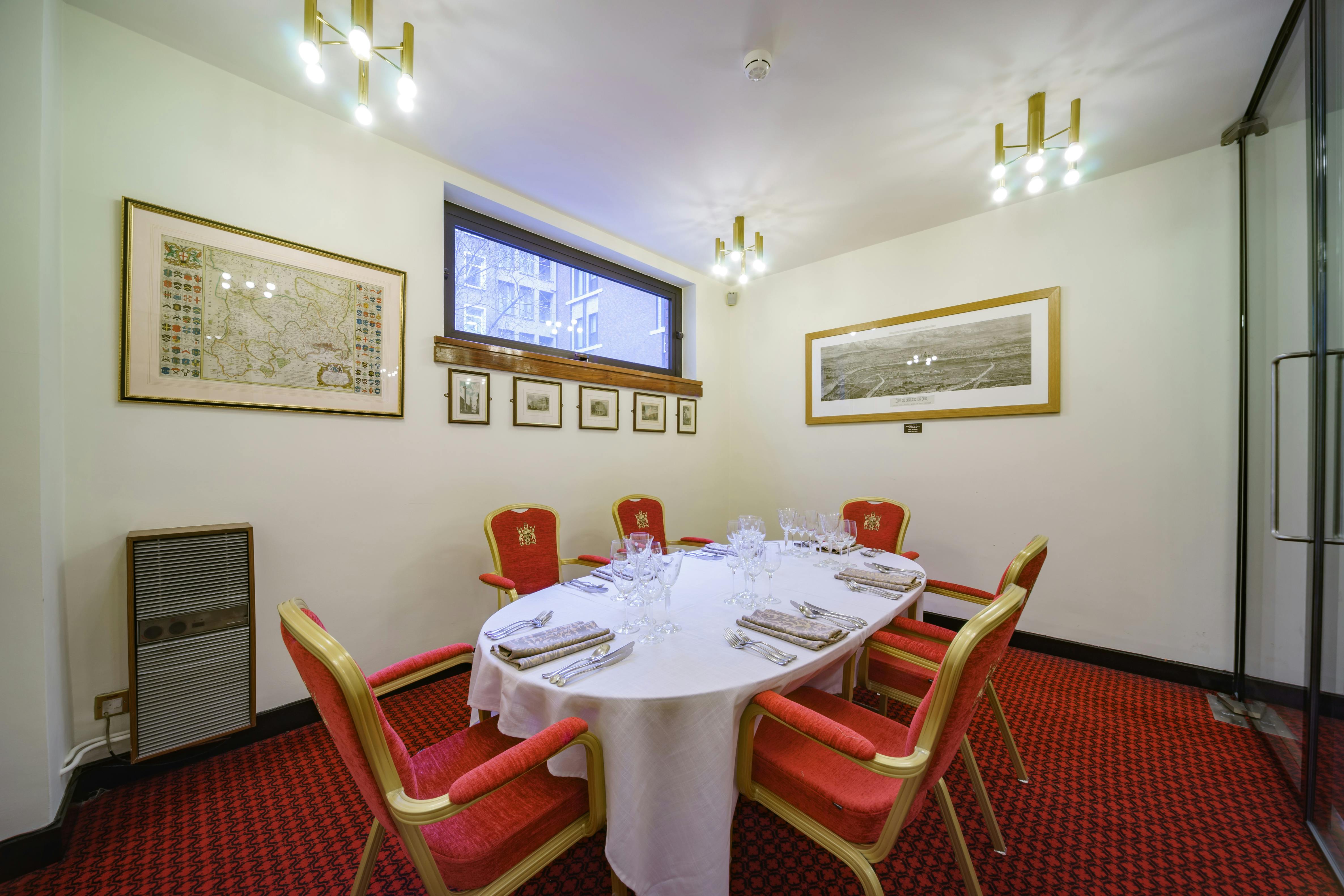 Elegant meeting room with round table at The Print Room, perfect for private dining events.