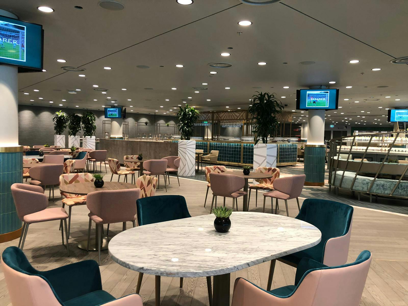 Modern event space in Wembley Stadium's Atrium with stylish seating for meetings and presentations.