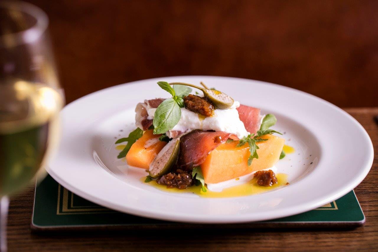 Irish Whisky Vault dish: cantaloupe, prosciutto, burrata for events and networking.