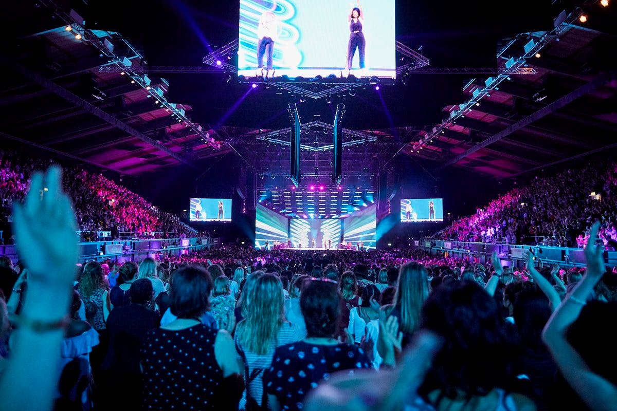 OVO Arena Wembley packed audience at a vibrant concert with dynamic lighting.