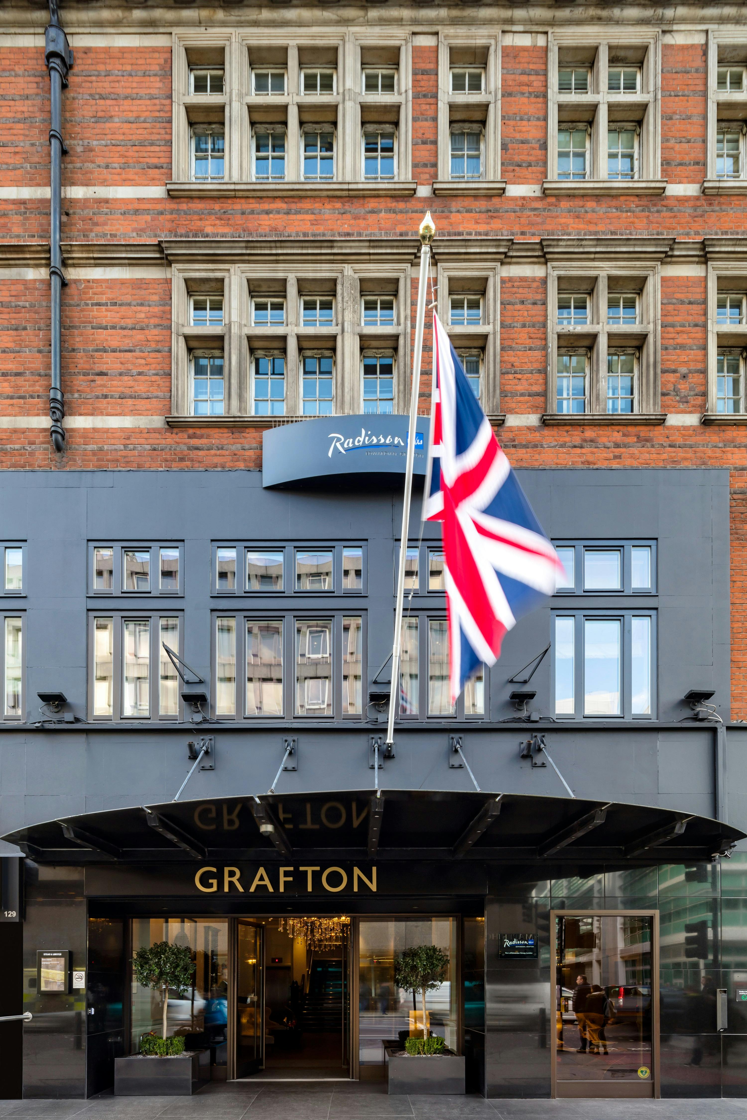 Radisson Blu Hotel exterior in London with British flag, ideal for corporate events.