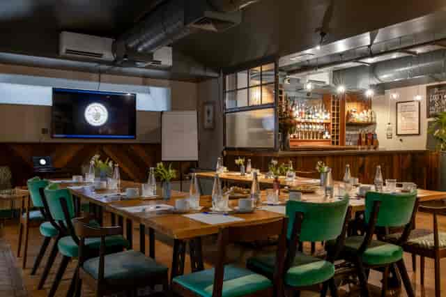 Cellar Bar meeting space with long tables, ideal for networking and presentations.
