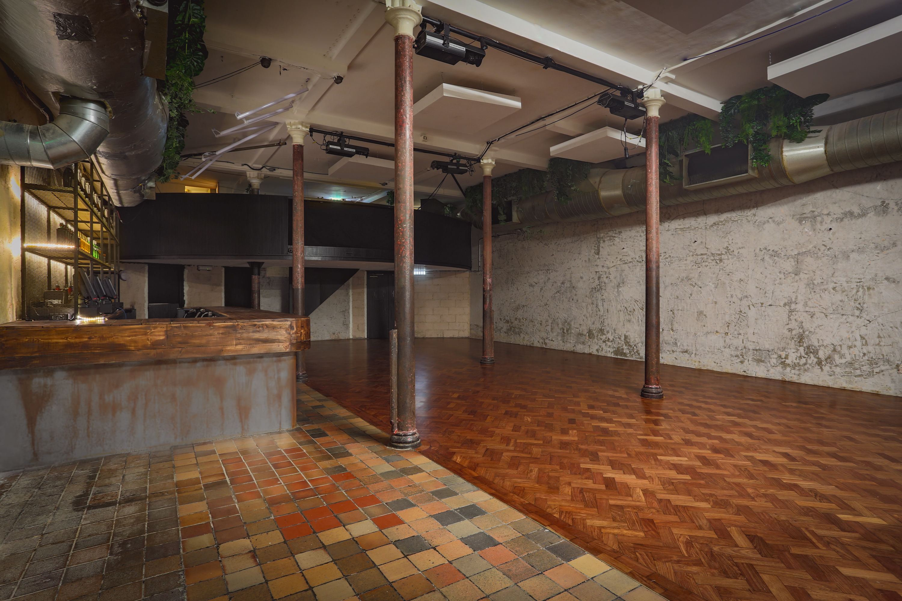 Versatile event space at 93 Feet East with polished wooden floor, ideal for gatherings.