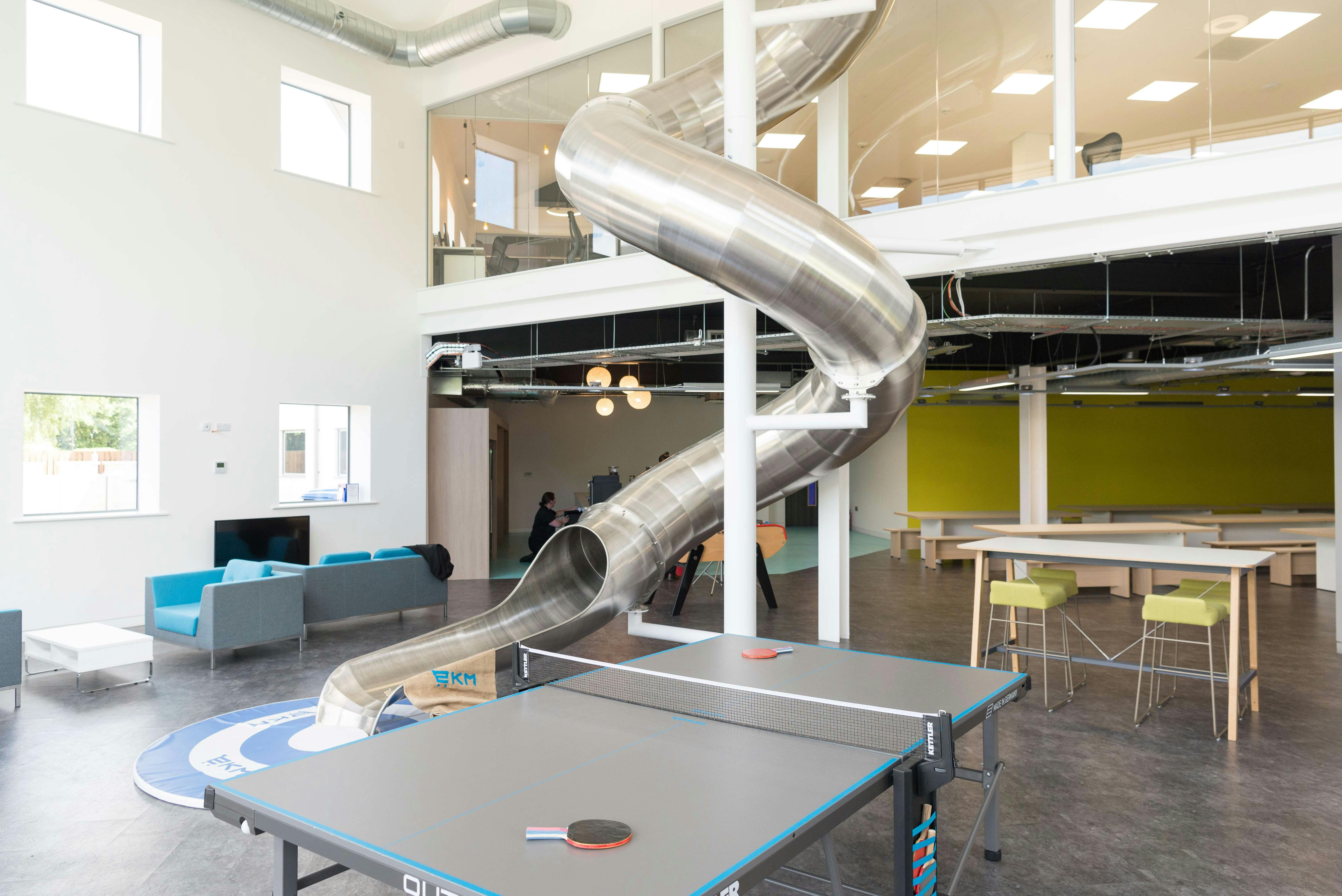 Modern auditorium with metal slide, ideal for creative events and team-building activities.