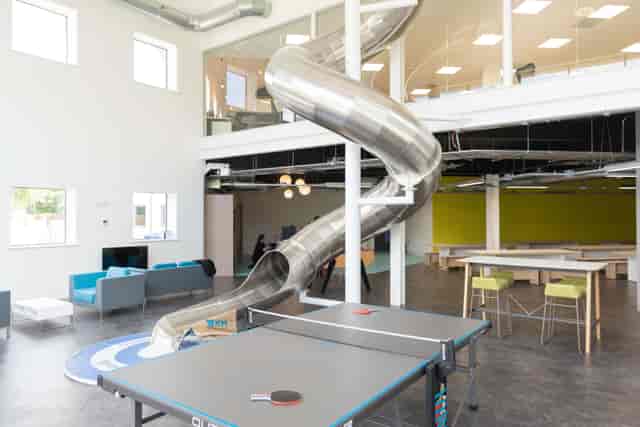 Modern auditorium with metal slide, ideal for creative events and team-building activities.