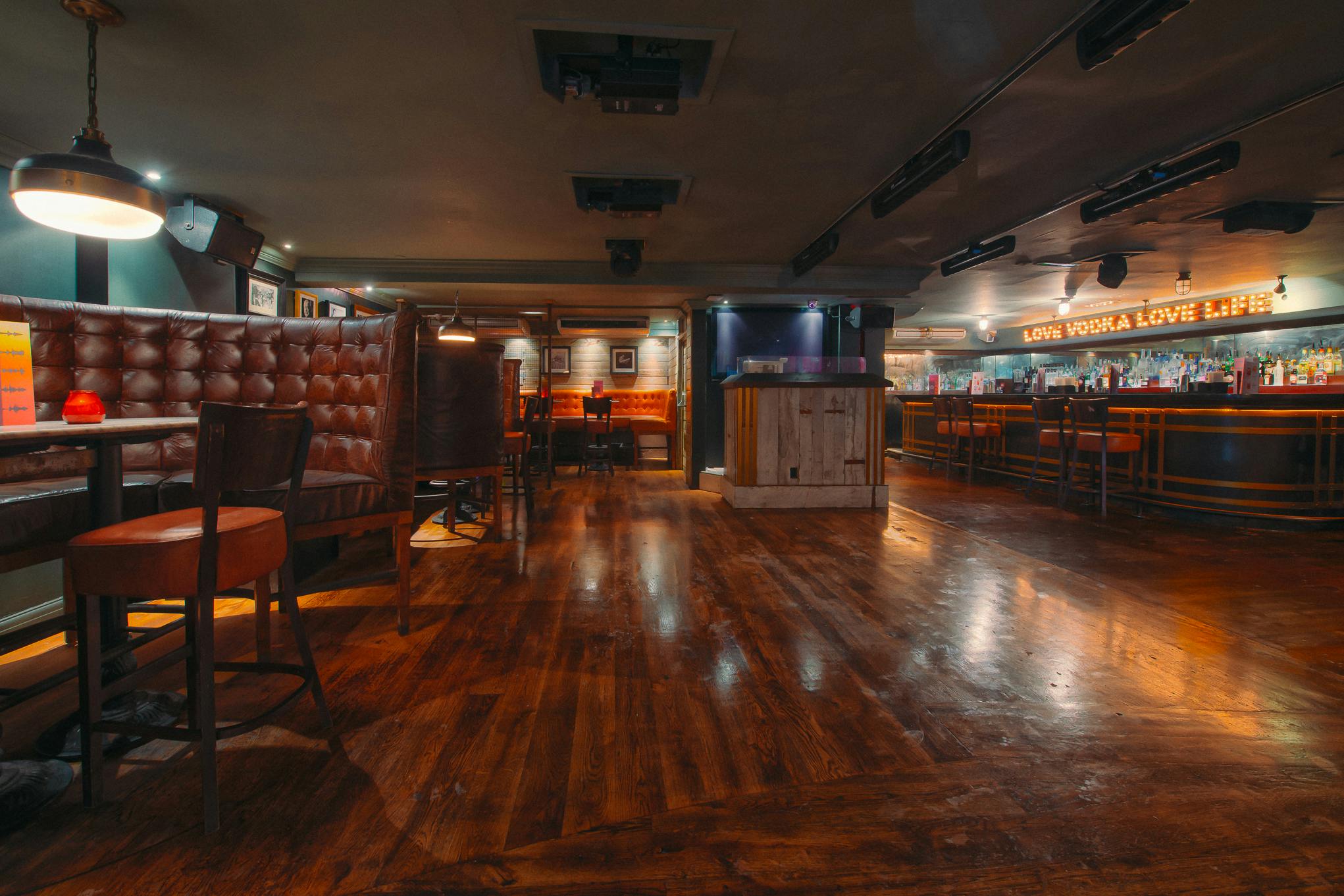 Versatile event space in Revolution Brighton with polished wooden floors for gatherings.