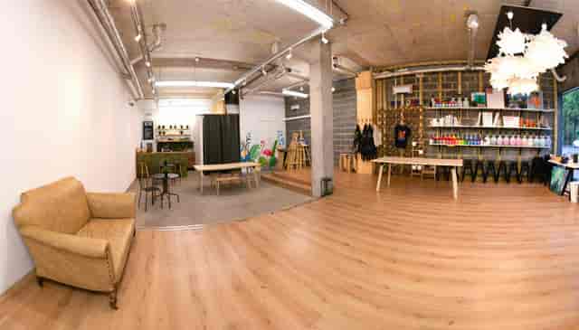 Versatile event space in Studio 249 with warm wooden flooring for workshops and networking.