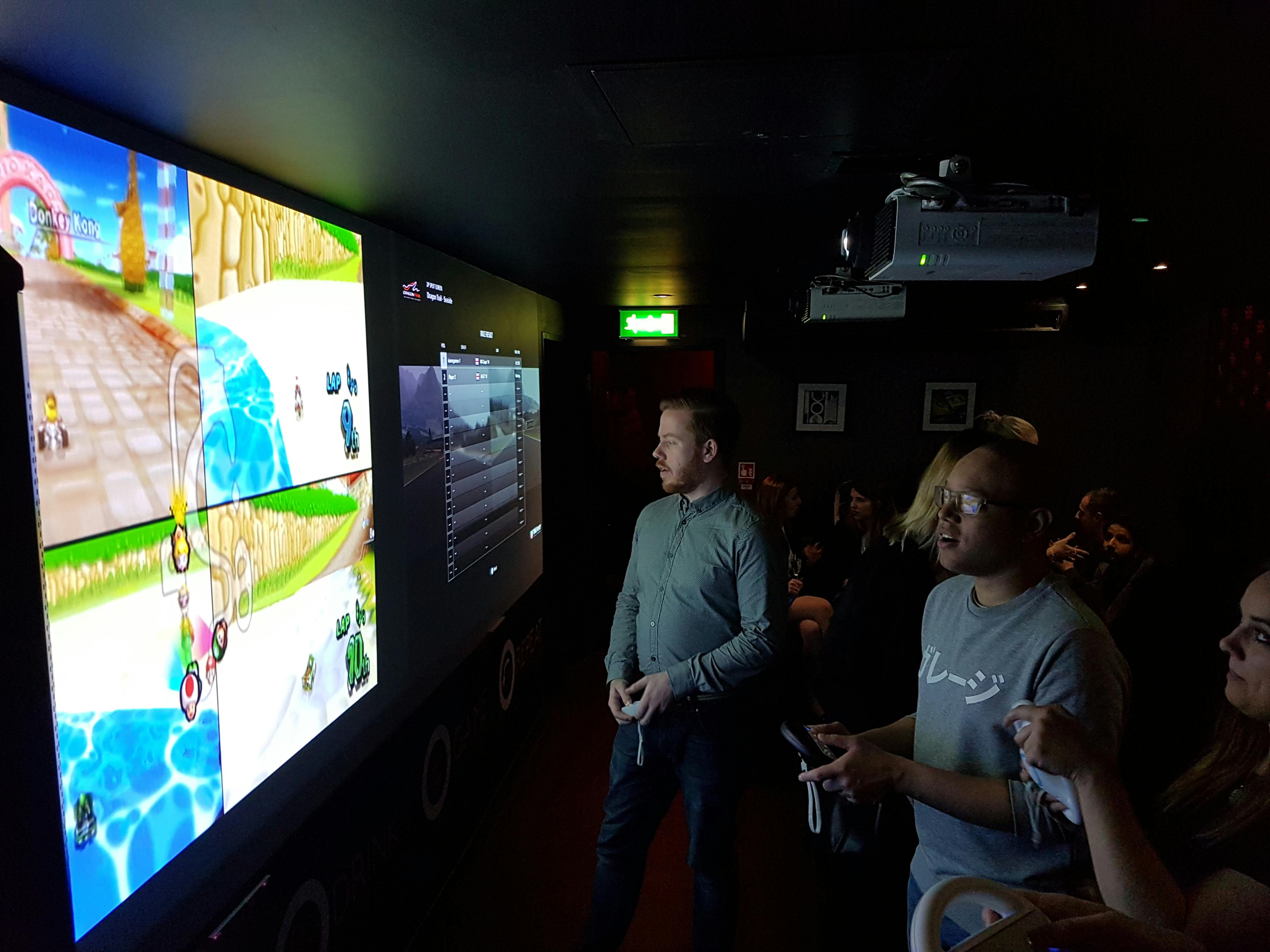 Dynamic team-building event in The Games Room with competitive gaming and vibrant racing.