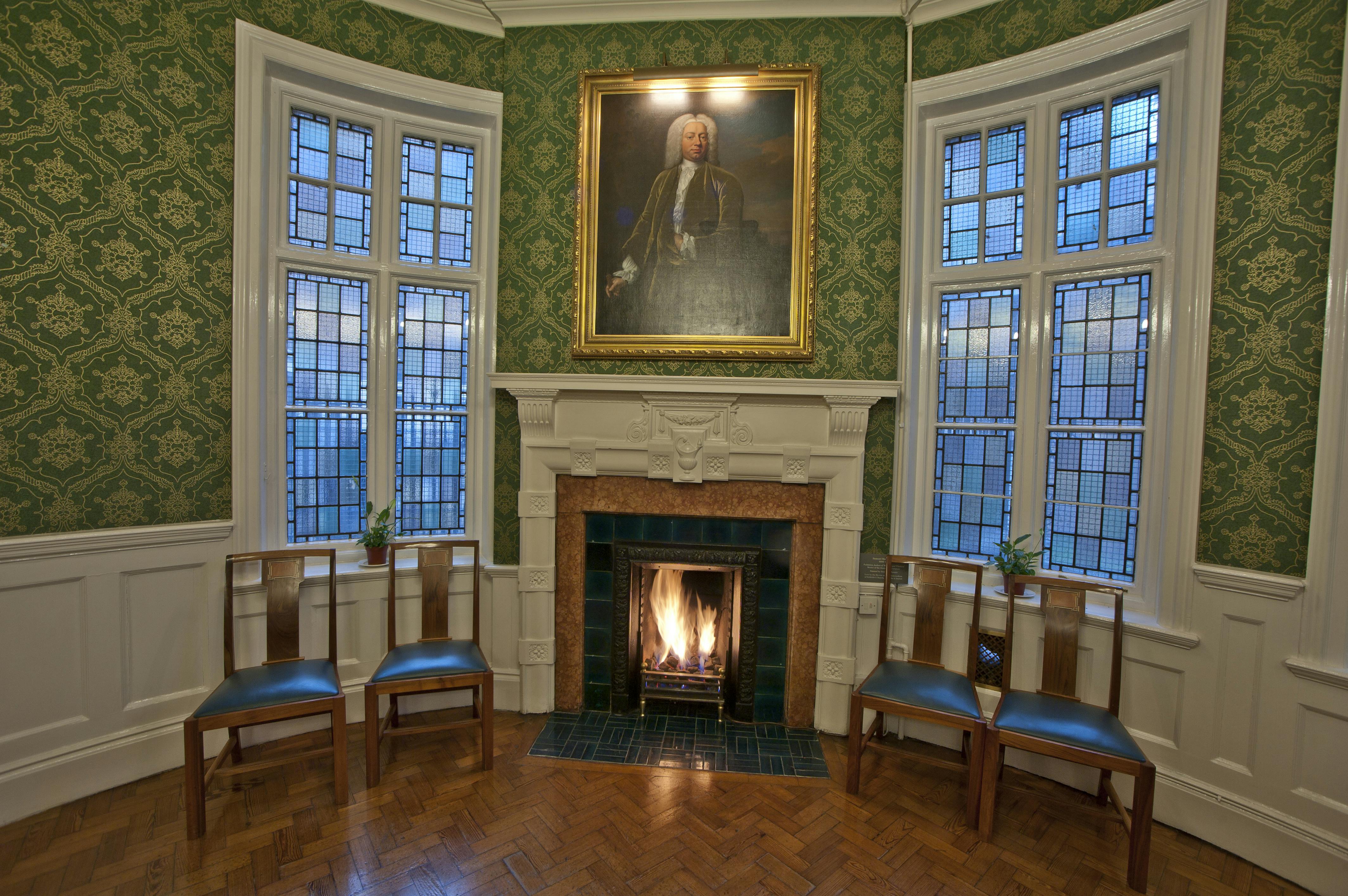 Salisbury Room at St Bride Foundation: elegant meeting space with warm fireplace, ideal for conferences.