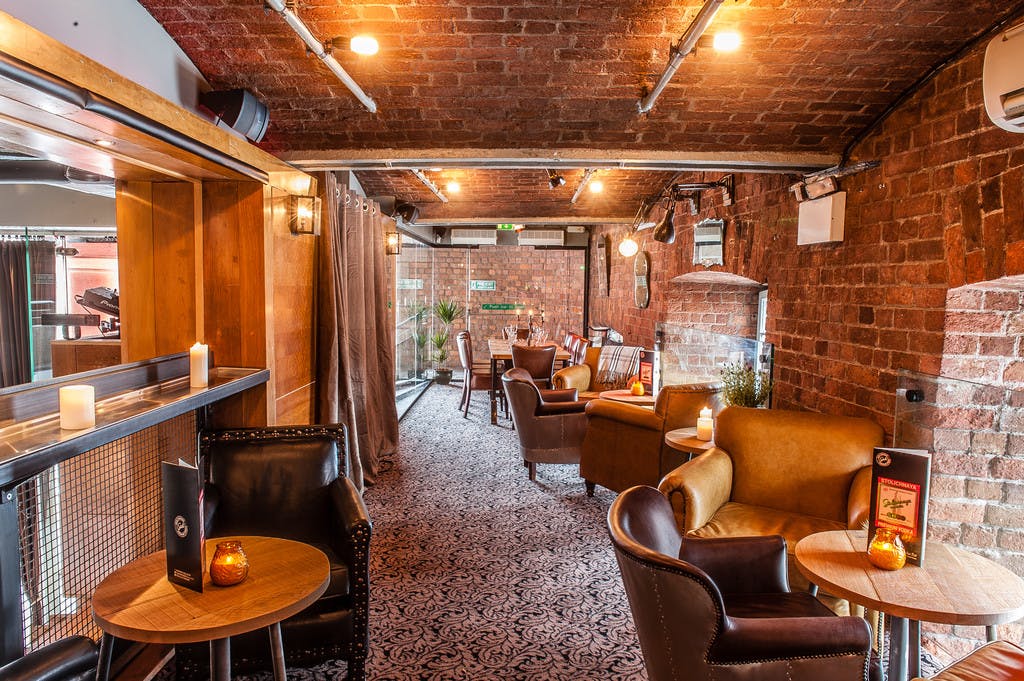 Sky Level at Revolution Albert Dock: cozy venue with exposed brick for networking events.