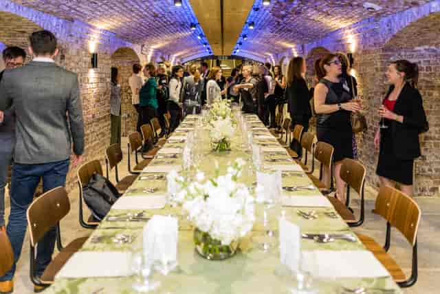London Bridge Arches event space with elegant floral centerpieces for corporate dinners.
