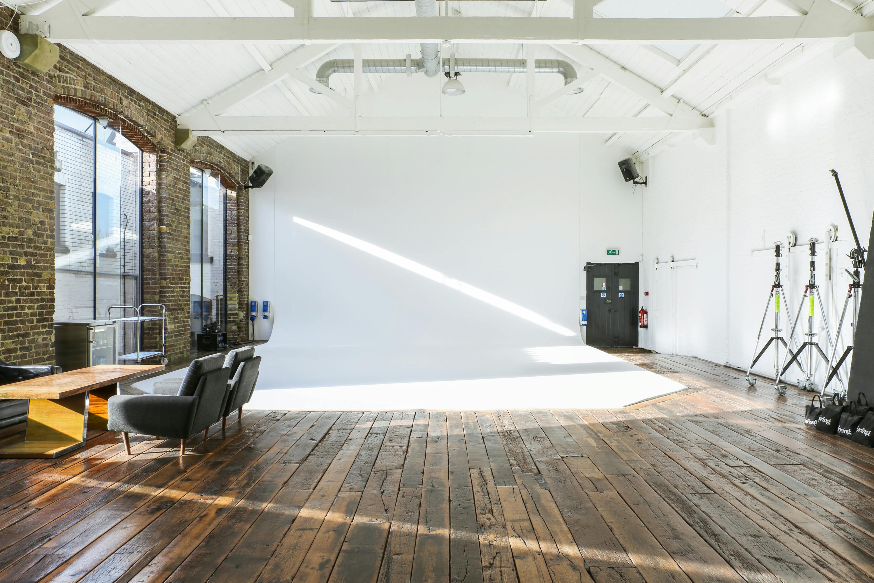 Versatile Studio C event space with natural light and wooden flooring for creative gatherings.