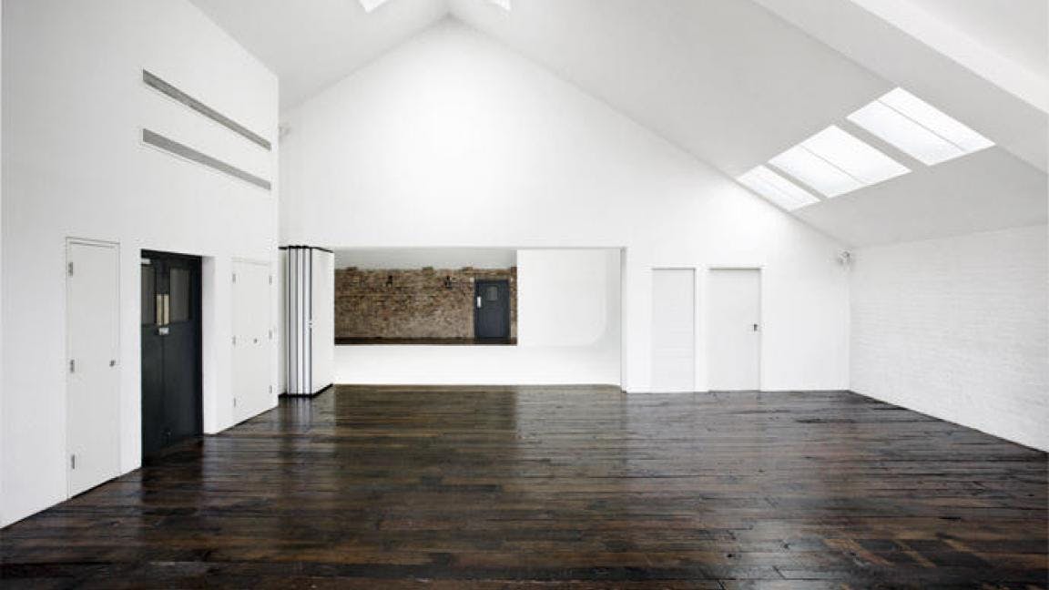 Spacious Studio E event space with high ceilings, ideal for corporate meetings and workshops.