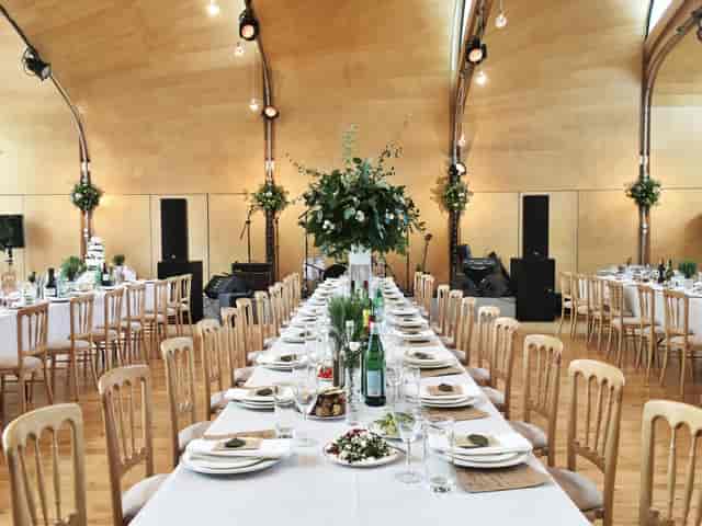 Elegant wedding banquet setup at Siobhan Davies Studios with lush centerpieces.