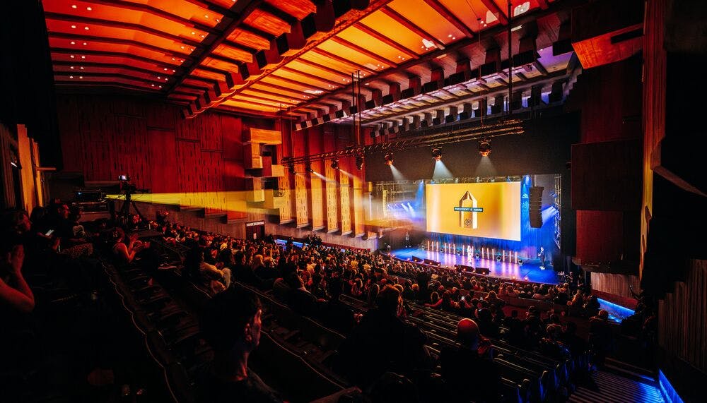 Queen Elizabeth Hall Auditorium with engaged audience, vibrant lighting for dynamic events.