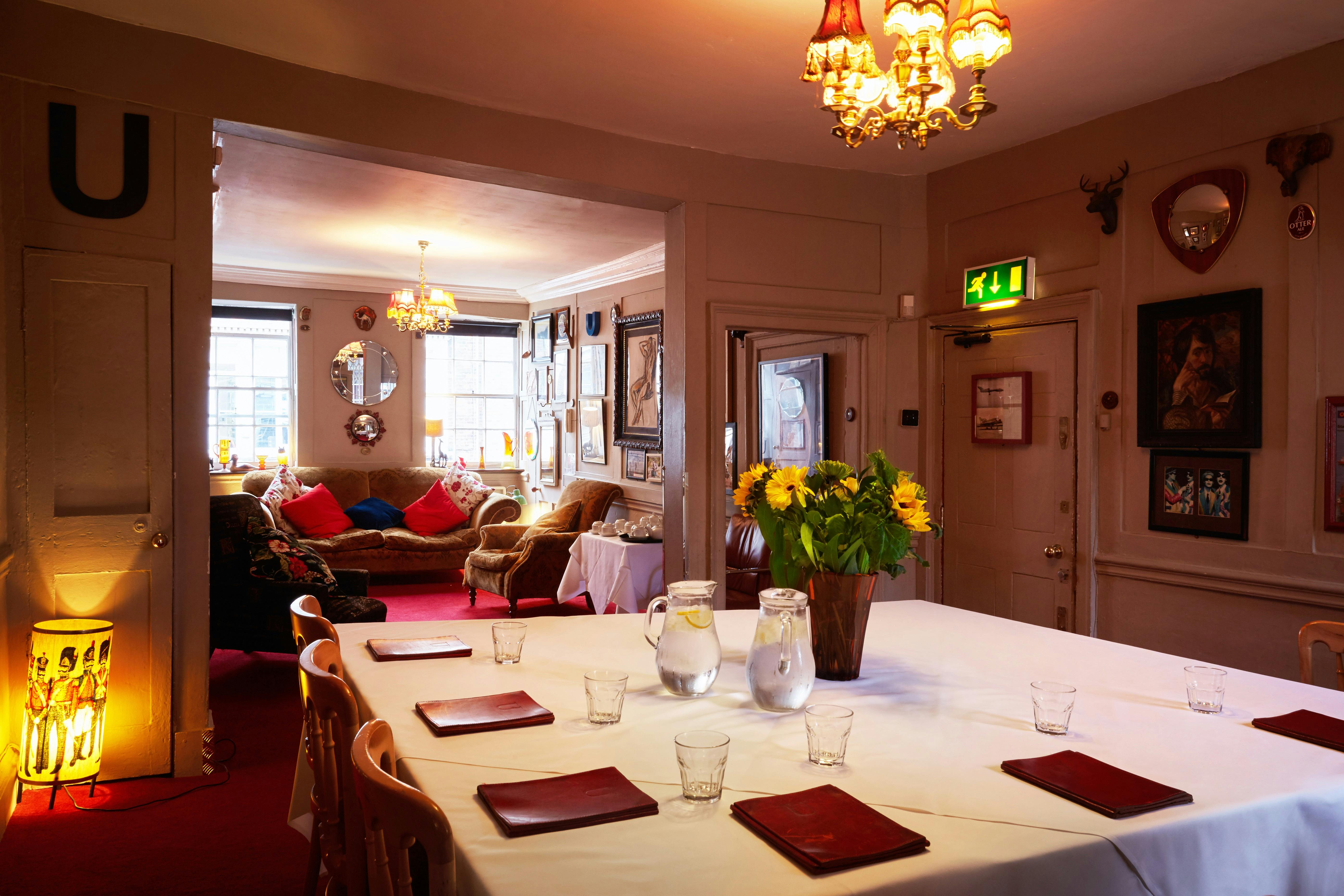 Cozy meeting room with long table, ideal for gatherings and brainstorming sessions.