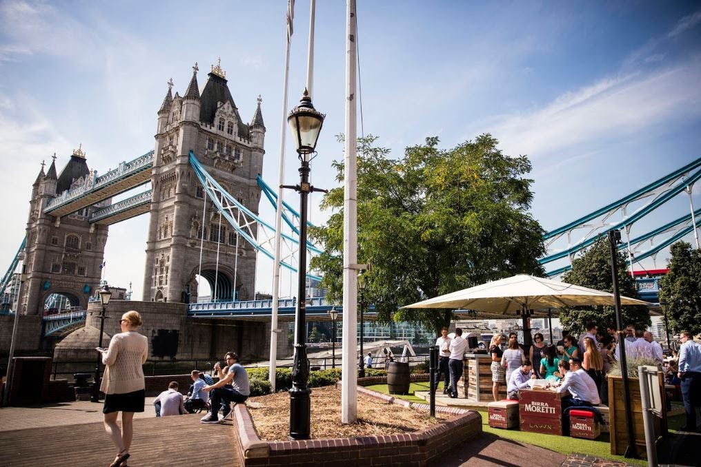 Outdoor event at The Lawn, Tower Hotel near Tower Bridge, featuring casual seating and greenery.