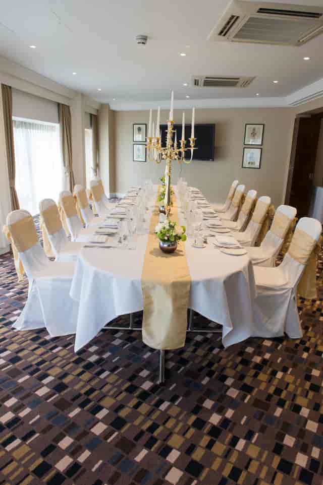 Elegant banquet setup with white linens and gold accents at Victory Services Club.