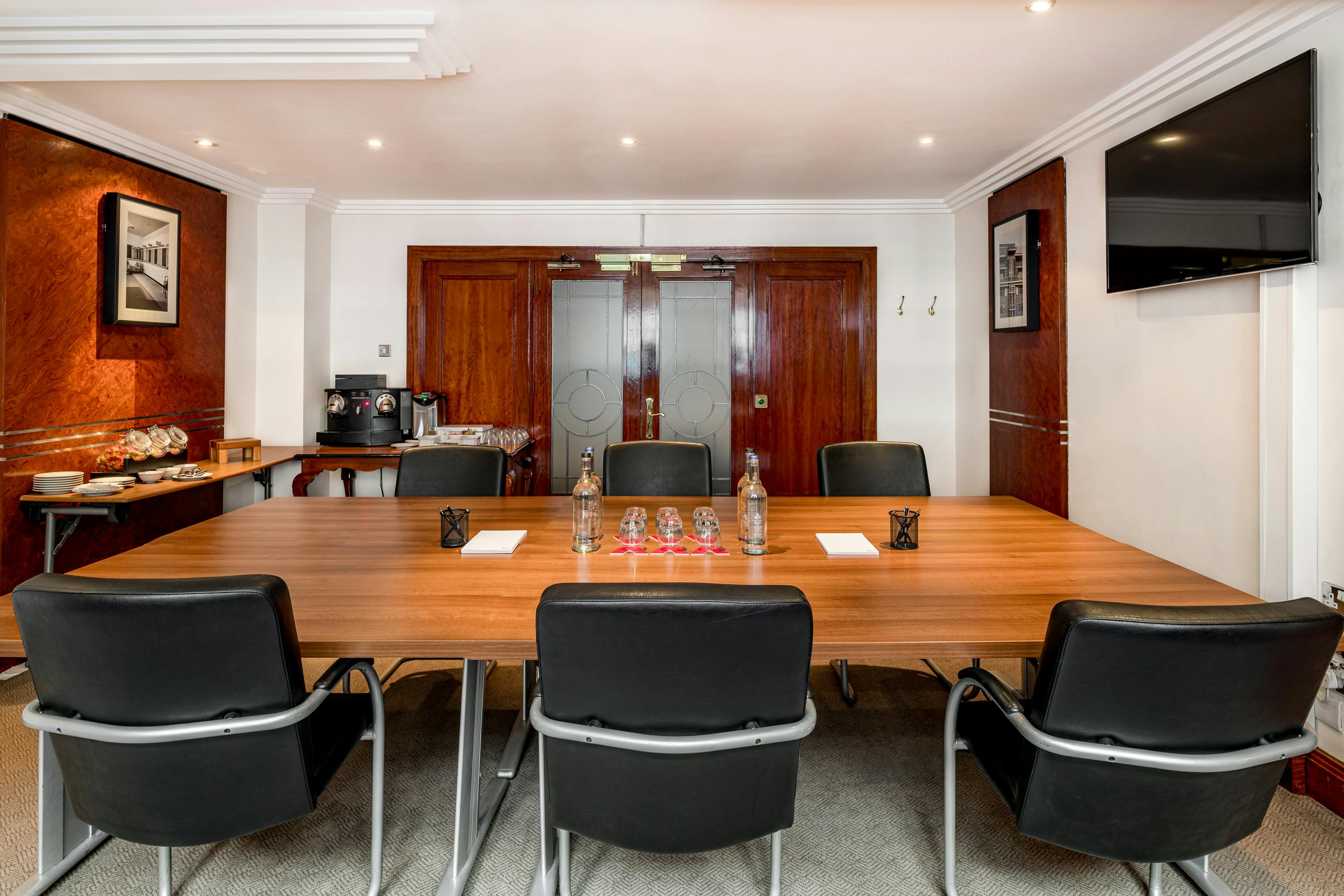 Mayfair meeting room with wooden table, ideal for professional gatherings and presentations.