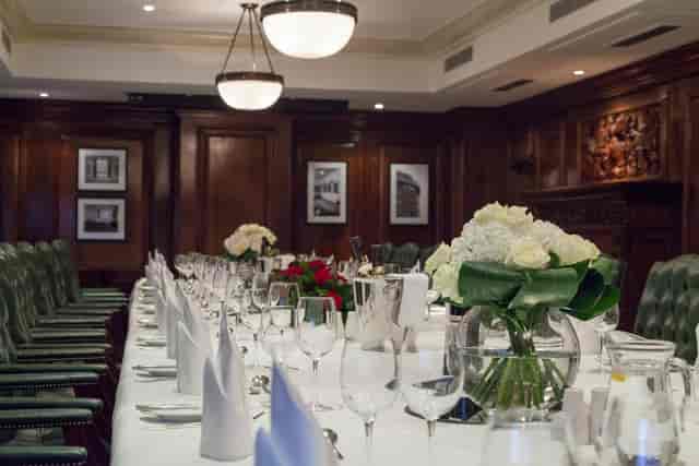 Elegant dinner setup at Speakers' Corner, Thistle Marble Arch, with floral centerpieces.