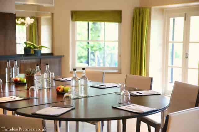 Garden Room 1 at The Bingham: round table meeting space with natural light for events.