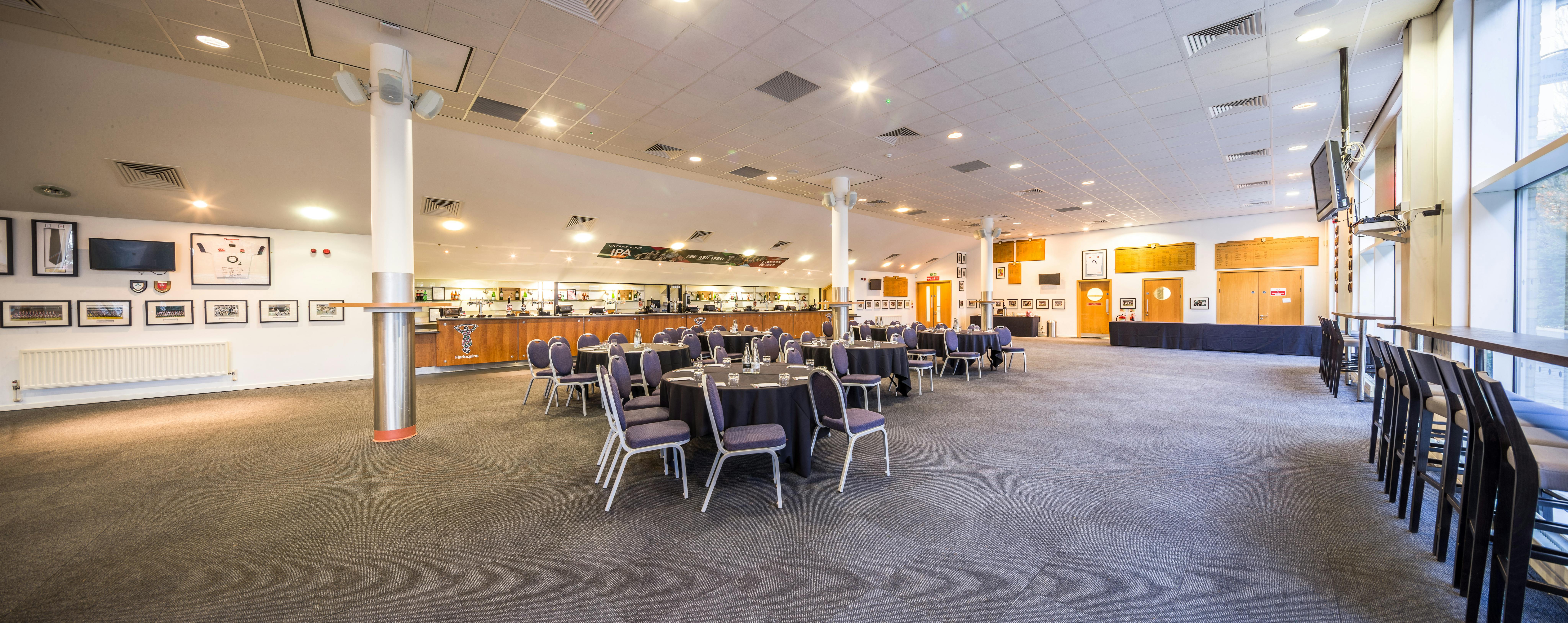 The Honours Bar at Twickenham Stoop, set for a formal event with round tables.