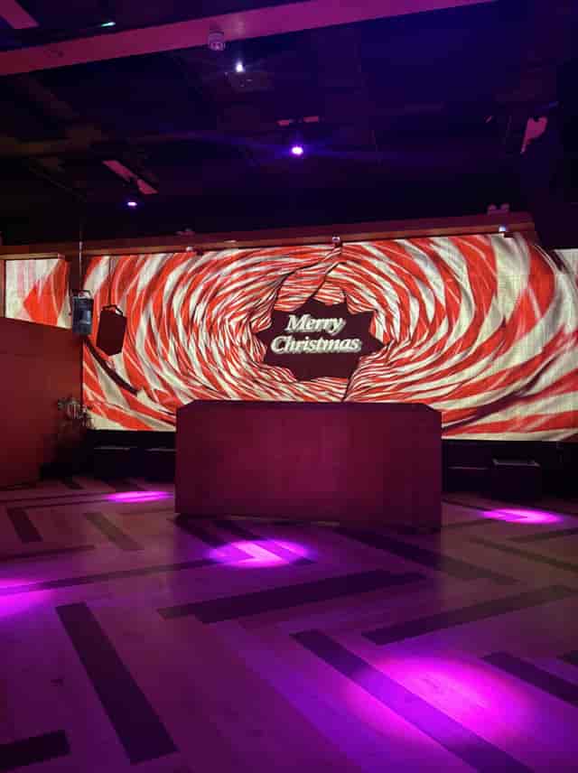 Vibrant holiday event space with candy-stripe backdrop for festive gatherings.
