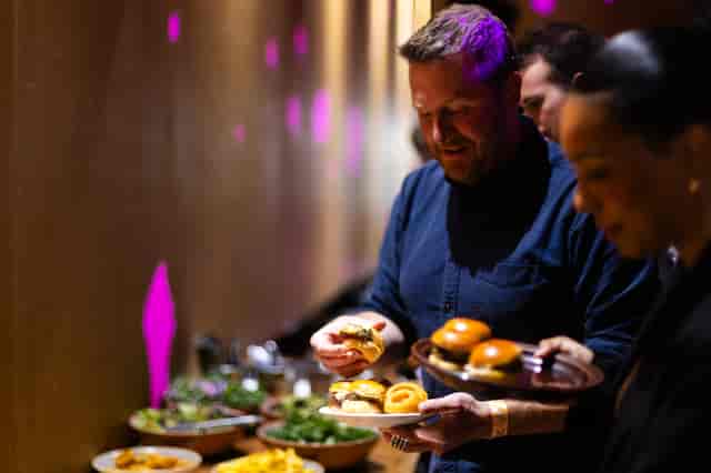 Guests enjoying a buffet at 90 Hideout, Hackney Wick - networking event atmosphere.