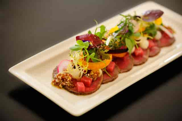 Upscale catering dish with vibrant ingredients in The Bingham's Garden Room 3.