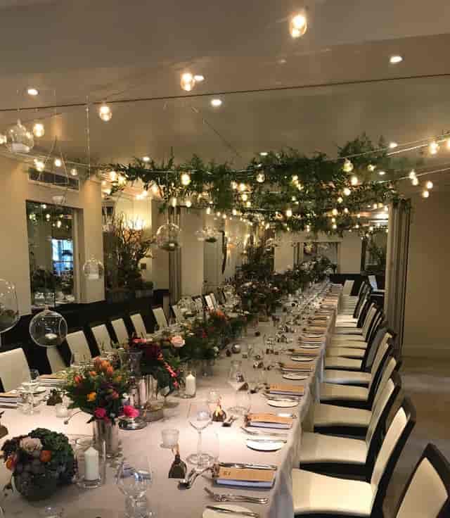 Elegant dining setup with floral centerpieces for weddings and corporate dinners.
