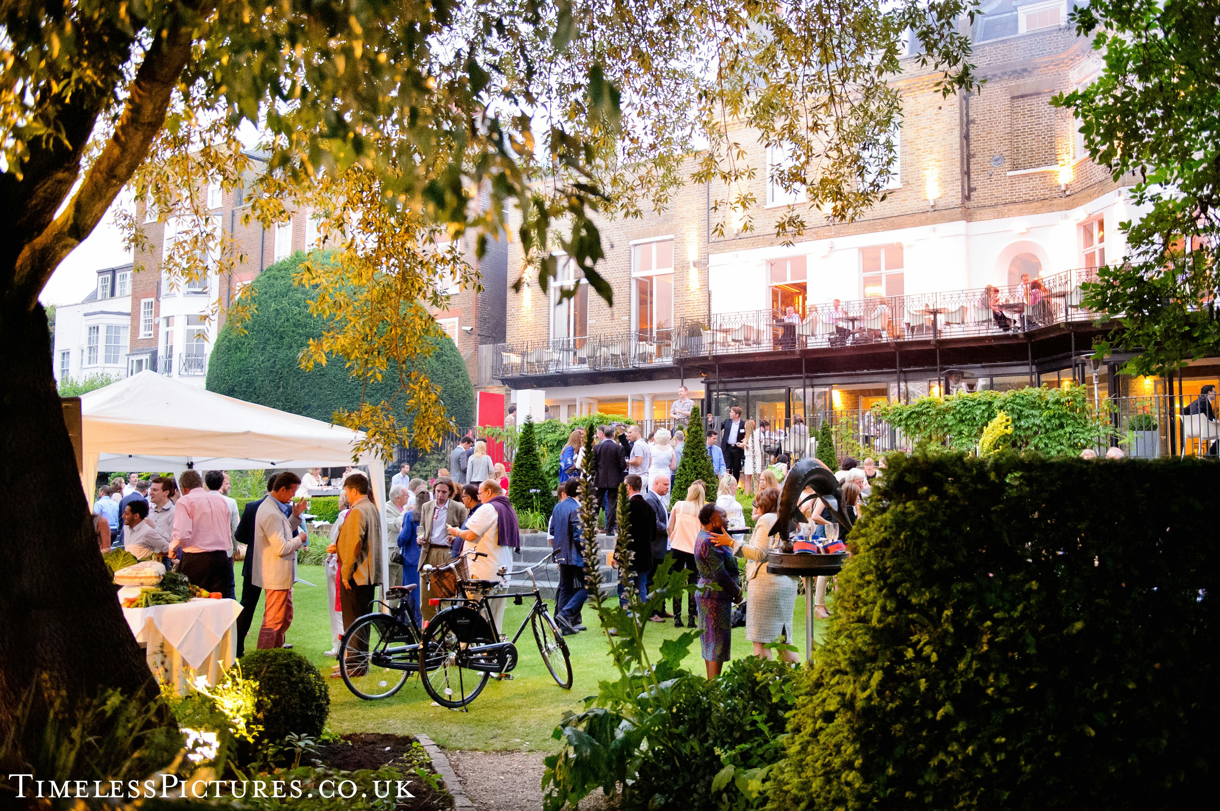 Vibrant garden event with elegant tents for networking and social gatherings at The Bingham.