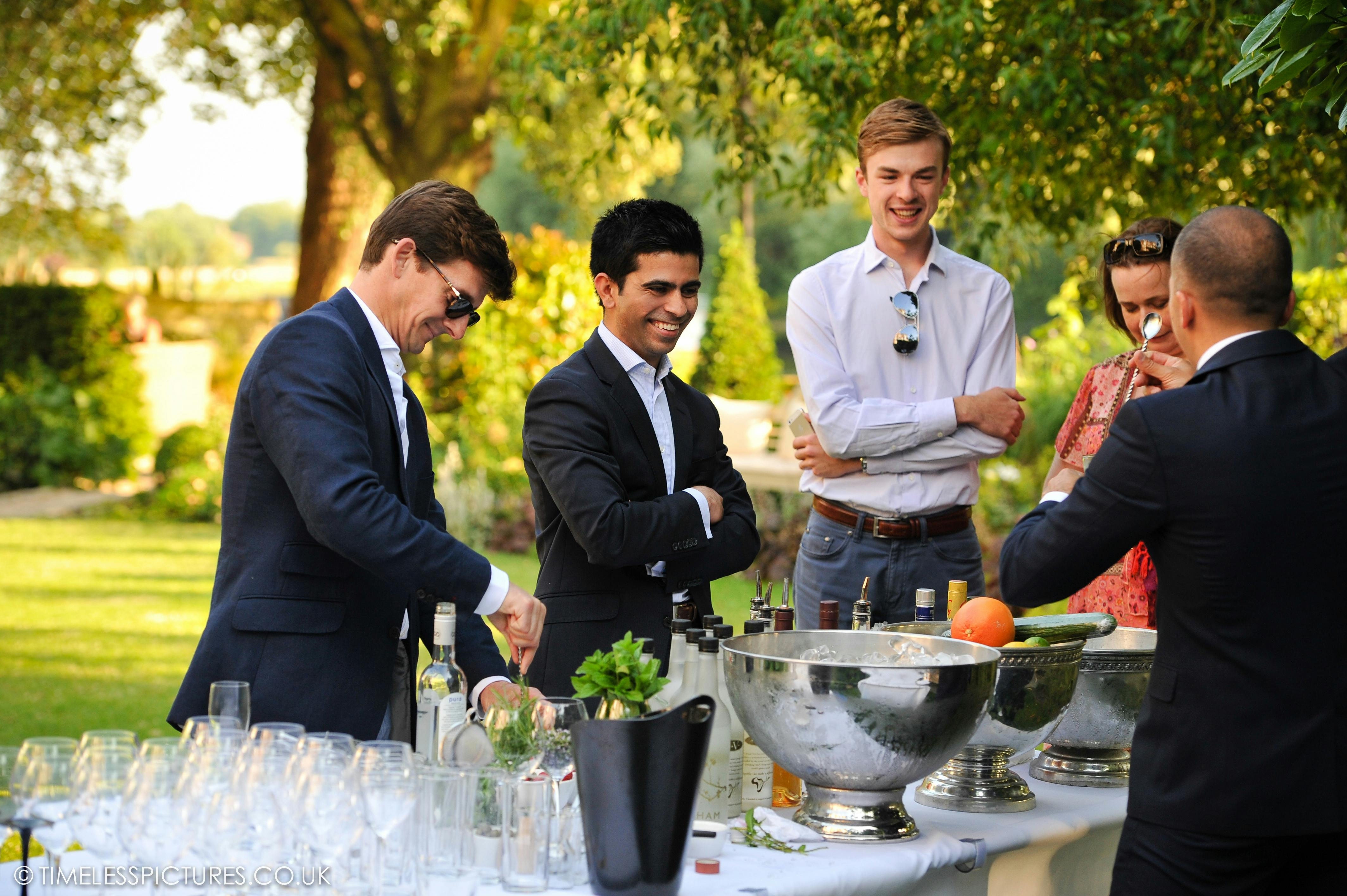 Outdoor networking event at The Bingham's lush terrace with refreshments and engaging conversations.