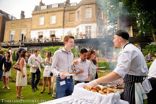 Outdoor barbecue event at The Bingham's Terrace & Garden with lush greenery.