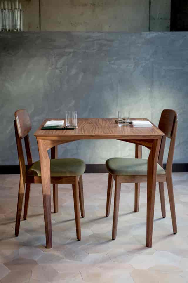 Sleek table for two in Londrino's modern restaurant, ideal for intimate meetings.